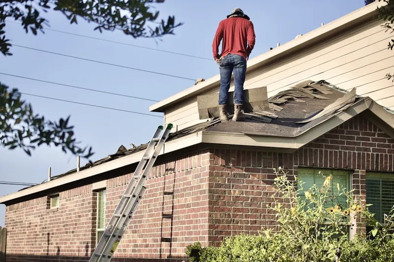 Professional roofer working on a residential roof in The Preserve at Greenwood Village
